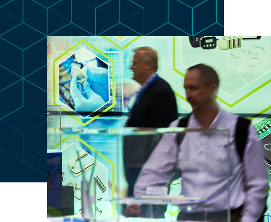 Two attendees examining products in the expo hall floor